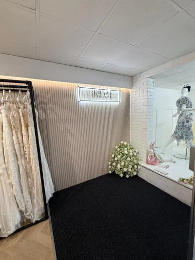 White panelled wall with bridal flowers at Bridal by Brittany Ann